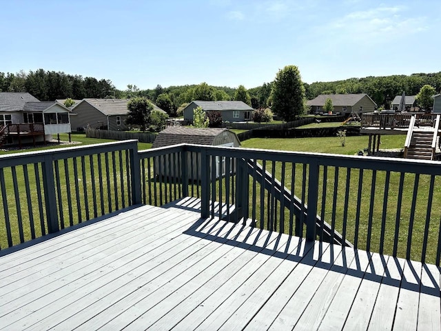 862 Stonefield Dr, Edgerton, WI 53534 - wooden deck featuring a shed, a residential view, and a fenced backyard