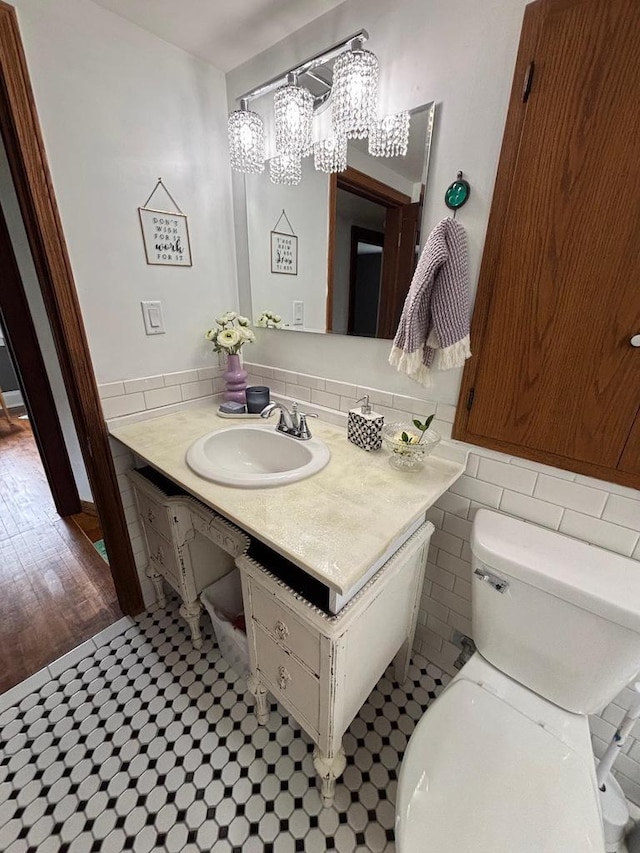 168 14th St, Fond Du Lac, WI 54935 - half bathroom featuring vanity and a chandelier