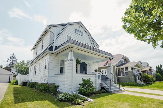 168 14th St, Fond Du Lac, WI 54935 - dutch colonial with a front lawn, a gambrel roof, and an outbuilding