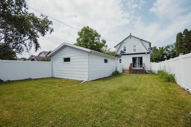 168 14th St, Fond Du Lac, WI 54935 - back of house with a fenced backyard, a gambrel roof, and an outdoor structure