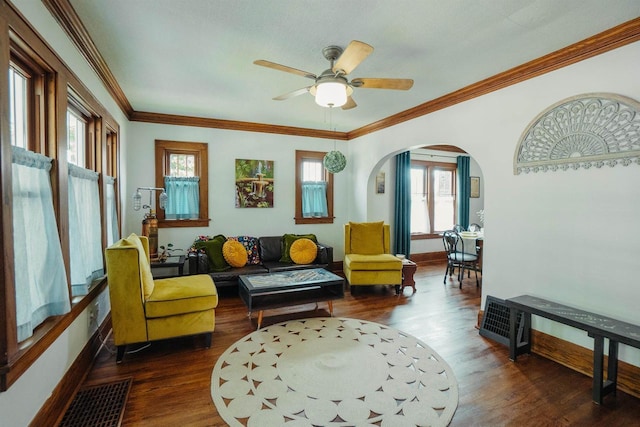 168 14th St, Fond Du Lac, WI 54935 - living room with arched walkways, dark wood-type flooring, a ceiling fan, and crown molding