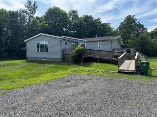 2779 250th Ave, Saint Croix Falls, WI 54024 - manufactured / mobile home featuring a wooden deck, a front lawn, and view of wooded area
