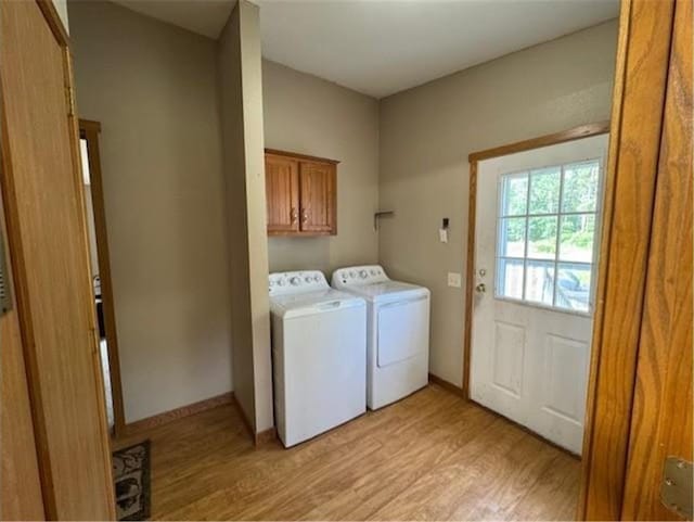 2779 250th Ave, Saint Croix Falls, WI 54024 - laundry area with cabinet space, light wood-style flooring, and washer and clothes dryer