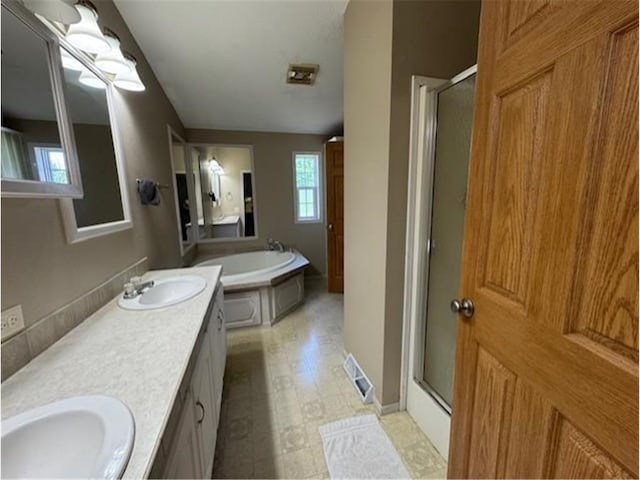 2779 250th Ave, Saint Croix Falls, WI 54024 - bathroom featuring a stall shower, a garden tub, double vanity, and tile patterned floors