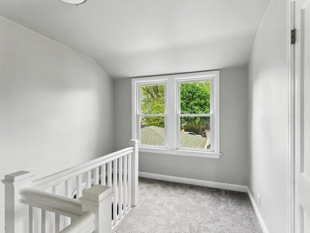 821 N 6th St, Manitowoc, WI 54220 - carpeted bedroom with vaulted ceiling and baseboards
