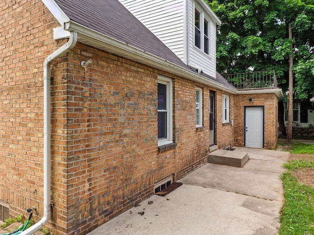 821 N 6th St, Manitowoc, WI 54220 - view of home's exterior featuring brick siding and a patio