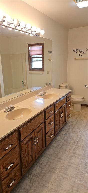 2931 148th Ave, Bloomer, WI 54724 - bathroom featuring double vanity and tile patterned floors