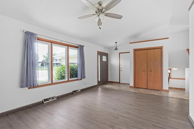 1335 Terapin Trl, Janesville, WI 53545 - unfurnished bedroom with vaulted ceiling, wood finished floors, multiple closets, and ceiling fan