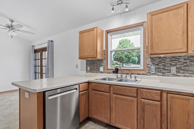 1335 Terapin Trl, Janesville, WI 53545 - kitchen with stainless steel dishwasher, a peninsula, decorative backsplash, and light countertops