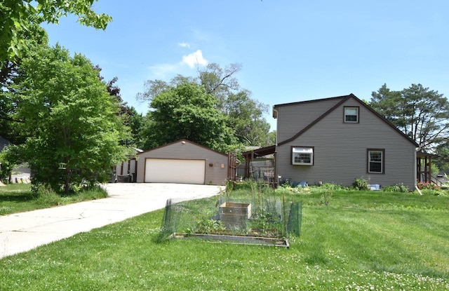10526 W Congress St, Wauwatosa, WI 53225 - view of side of home with a detached garage, an outdoor structure, a yard, and a vegetable garden