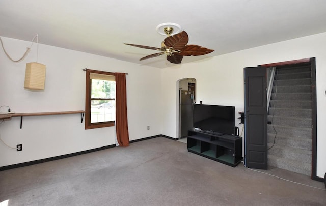 10526 W Congress St, Wauwatosa, WI 53225 - unfurnished living room featuring arched walkways, a ceiling fan, stairs, and carpet floors