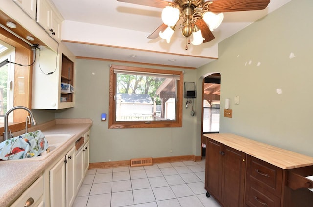 10526 W Congress St, Wauwatosa, WI 53225 - kitchen featuring arched walkways, white cabinets, light tile patterned flooring, ceiling fan, and dark brown cabinets