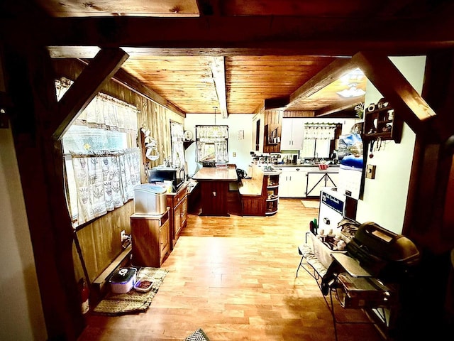 12830 Thunder Hollow Rd, Whitelaw, WI 54247 - kitchen featuring light wood-type flooring, a wood ceiling with exposed beams, and white cabinets