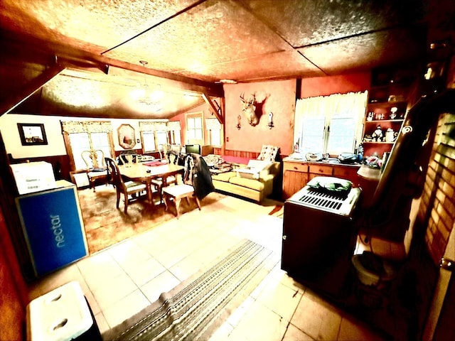 12830 Thunder Hollow Rd, Whitelaw, WI 54247 - dining area with a chandelier, lofted ceiling, and light tile patterned floors