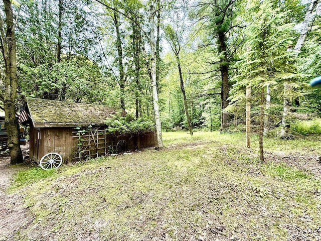 12830 Thunder Hollow Rd, Whitelaw, WI 54247 - view of yard with an outdoor structure and a forest view