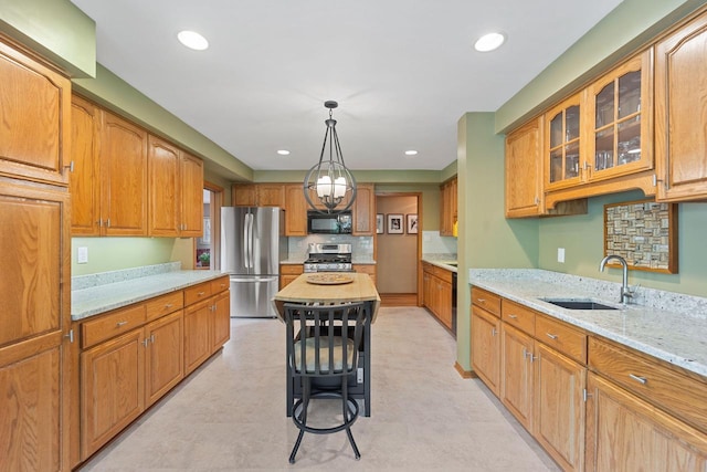 1060 Hawthorne Ln, Brookfield, WI 53005 - kitchen with appliances with stainless steel finishes, glass insert cabinets, light stone counters, recessed lighting, and pendant lighting