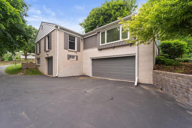 1060 Hawthorne Ln, Brookfield, WI 53005 - view of front facade with an attached garage, brick siding, and asphalt driveway