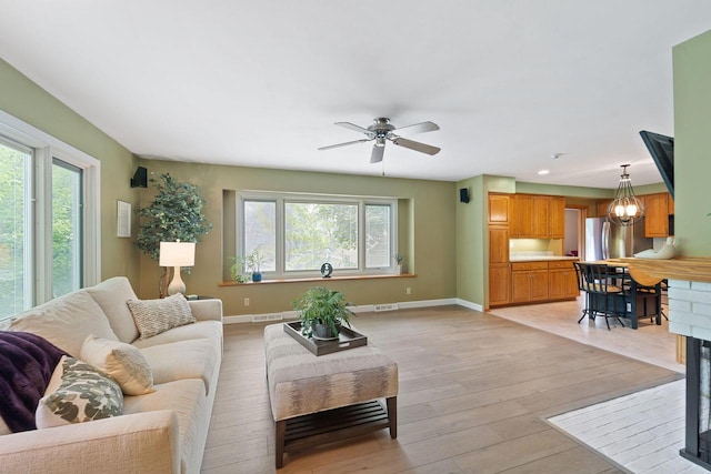 1060 Hawthorne Ln, Brookfield, WI 53005 - living room featuring healthy amount of natural light, light wood-style floors, a ceiling fan, and recessed lighting