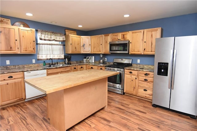 6782 55th St, Chippewa Falls, WI 54729 - kitchen featuring stainless steel appliances, butcher block countertops, light brown cabinets, a kitchen island, and light wood-type flooring