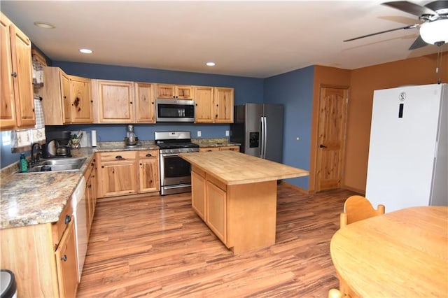6782 55th St, Chippewa Falls, WI 54729 - kitchen with appliances with stainless steel finishes, wooden counters, light brown cabinetry, a ceiling fan, and light wood-type flooring
