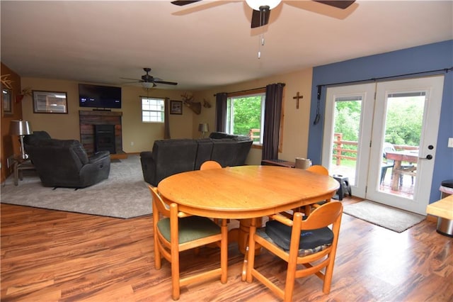 6782 55th St, Chippewa Falls, WI 54729 - dining area featuring light wood-style flooring, ceiling fan, and a fireplace
