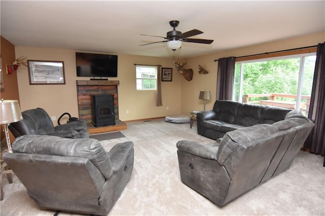 6782 55th St, Chippewa Falls, WI 54729 - living room featuring a wood stove, light colored carpet, and ceiling fan