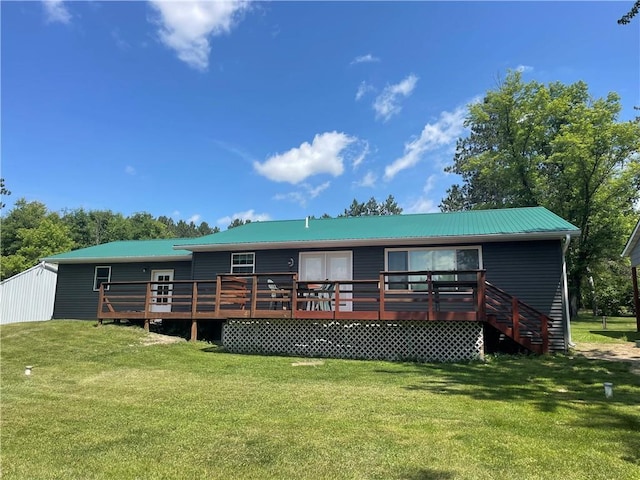 6782 55th St, Chippewa Falls, WI 54729 - rear view of house with a deck, a yard, and a metal roof