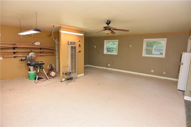 6782 55th St, Chippewa Falls, WI 54729 - basement with freestanding refrigerator, a ceiling fan, and a heating unit
