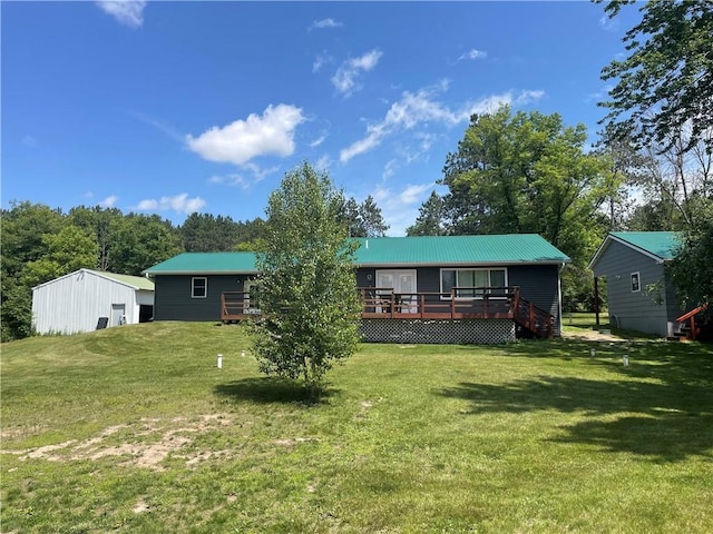 6782 55th St, Chippewa Falls, WI 54729 - back of property with a deck, a lawn, and a metal roof