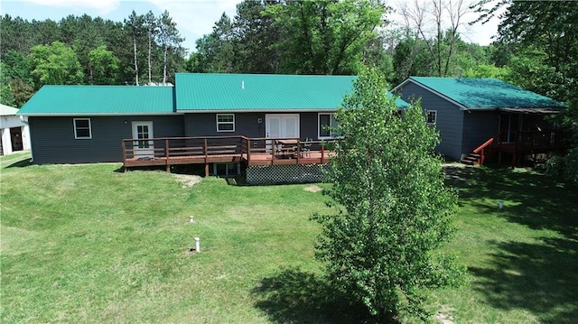 6782 55th St, Chippewa Falls, WI 54729 - back of property with a wooden deck, a metal roof, and a yard