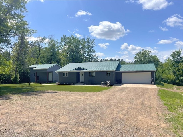 6782 55th St, Chippewa Falls, WI 54729 - single story home with dirt driveway, a garage, a front lawn, and a metal roof