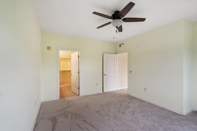 5196 Sassafras Dr Unit 313, Fitchburg, WI 53711 - unfurnished bedroom featuring carpet floors, a walk in closet, ceiling fan, and a closet