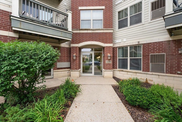5196 Sassafras Dr Unit 313, Fitchburg, WI 53711 - entrance to property with brick siding, a balcony, and french doors