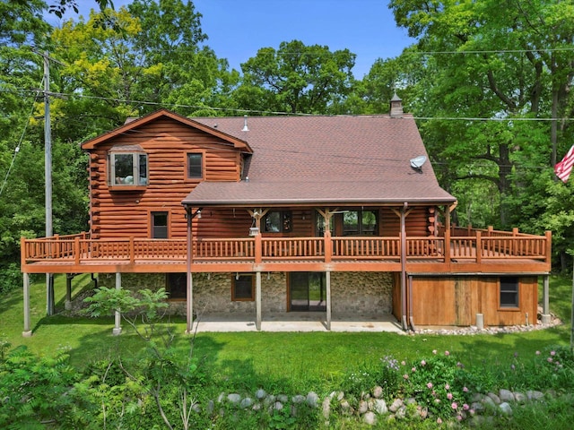 5633 Contour Rd, Waterford, WI 53185 - rear view of house featuring log exterior, a patio area, and a lawn