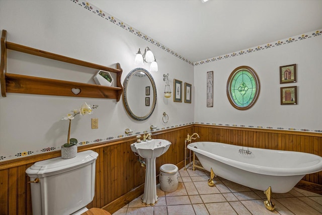 5633 Contour Rd, Waterford, WI 53185 - full bath featuring a freestanding tub, wainscoting, tile patterned flooring, and wood walls