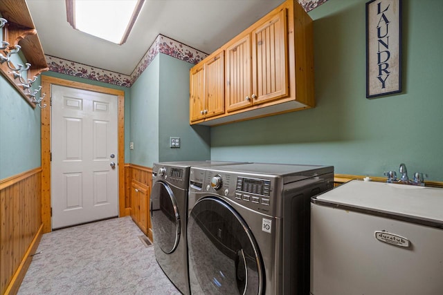 5633 Contour Rd, Waterford, WI 53185 - laundry room with washing machine and clothes dryer, wainscoting, cabinet space, wood walls, and light colored carpet