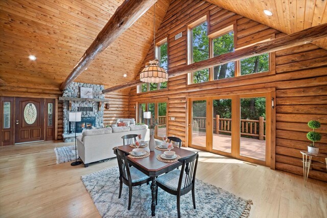 5633 Contour Rd, Waterford, WI 53185 - dining area featuring high vaulted ceiling, log walls, a wooden ceiling with exposed beams, french doors, and a stone fireplace