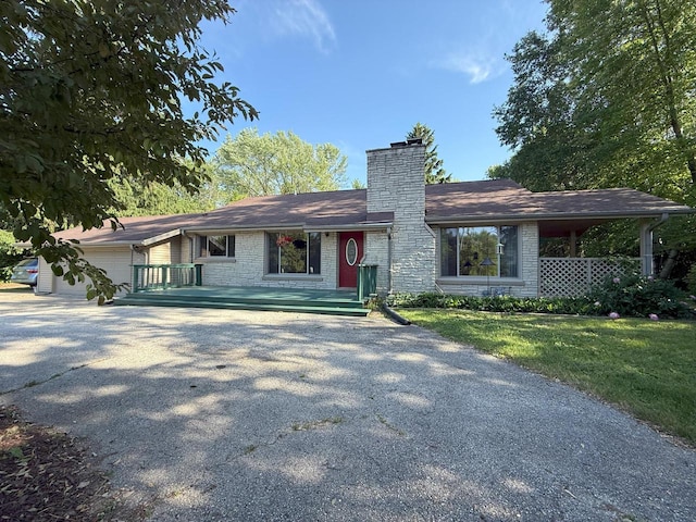 N72W14281 Good Hope Rd, Menomonee Falls, WI 53051 - view of front of property featuring driveway, a chimney, a garage, and a front yard