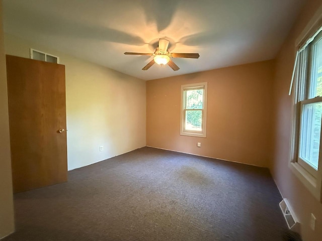 N72W14281 Good Hope Rd, Menomonee Falls, WI 53051 - empty room featuring plenty of natural light, ceiling fan, and dark colored carpet