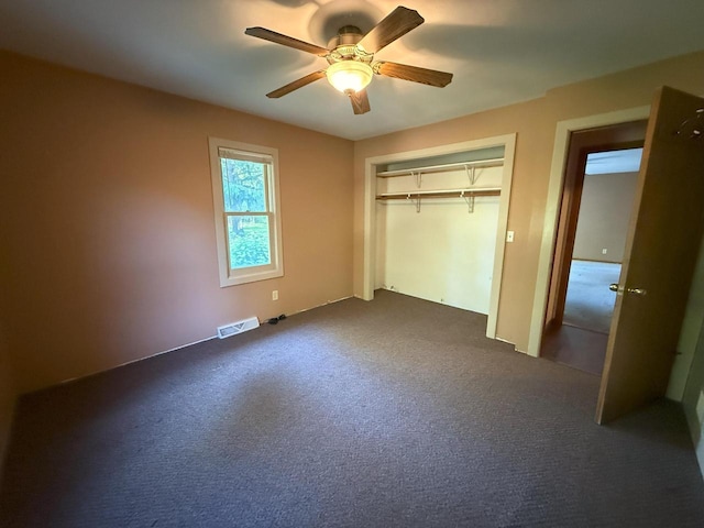 N72W14281 Good Hope Rd, Menomonee Falls, WI 53051 - unfurnished bedroom with dark carpet, a ceiling fan, and a closet