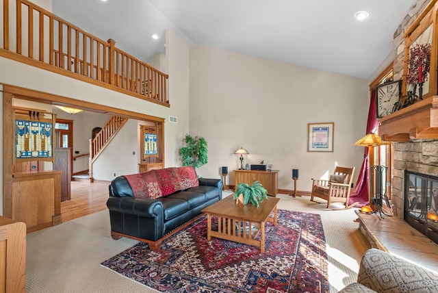 4570 Stoney Creek Rd, West Bend, WI 53095 - living room with stairway, carpet floors, high vaulted ceiling, a fireplace, and recessed lighting
