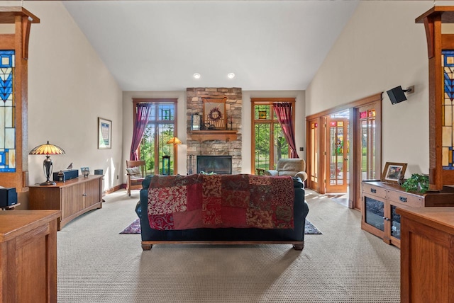 4570 Stoney Creek Rd, West Bend, WI 53095 - living room featuring light carpet, healthy amount of natural light, a stone fireplace, vaulted ceiling, and recessed lighting