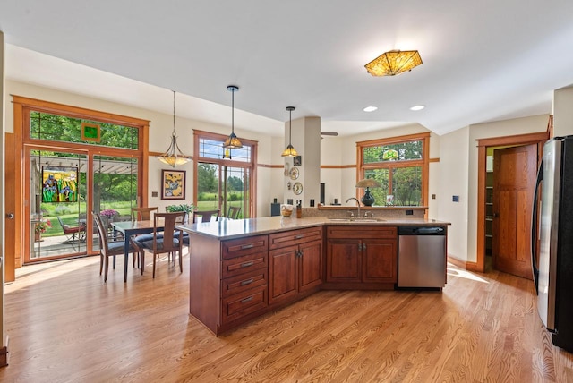 4570 Stoney Creek Rd, West Bend, WI 53095 - kitchen featuring appliances with stainless steel finishes, light wood finished floors, healthy amount of natural light, and recessed lighting