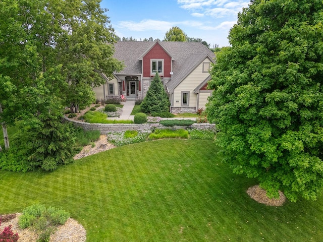 4570 Stoney Creek Rd, West Bend, WI 53095 - view of front facade with stone siding and a front yard