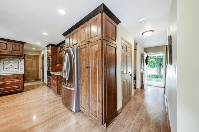 14240 Radiant Ct, Brookfield, WI 53005 - kitchen featuring stainless steel appliances, light wood-style flooring, recessed lighting, and light stone counters