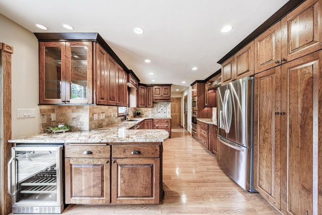14240 Radiant Ct, Brookfield, WI 53005 - kitchen featuring stainless steel appliances, wine cooler, light wood-style flooring, decorative backsplash, and glass insert cabinets