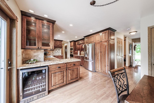 14240 Radiant Ct, Brookfield, WI 53005 - kitchen featuring beverage cooler, stainless steel fridge, tasteful backsplash, light wood-style floors, and glass insert cabinets