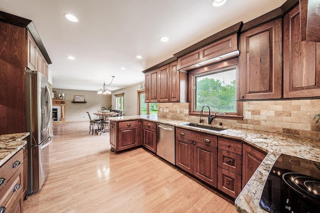 14240 Radiant Ct, Brookfield, WI 53005 - kitchen featuring appliances with stainless steel finishes, recessed lighting, light stone countertops, light wood-style flooring, and tasteful backsplash