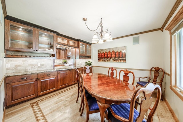 14240 Radiant Ct, Brookfield, WI 53005 - dining room featuring light wood finished floors, a chandelier, and crown molding