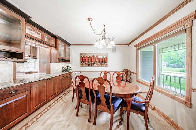 14240 Radiant Ct, Brookfield, WI 53005 - dining space with light wood-style flooring, ornamental molding, and a chandelier